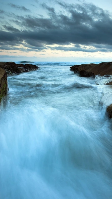Ocean Waves Flowing Between Rocks