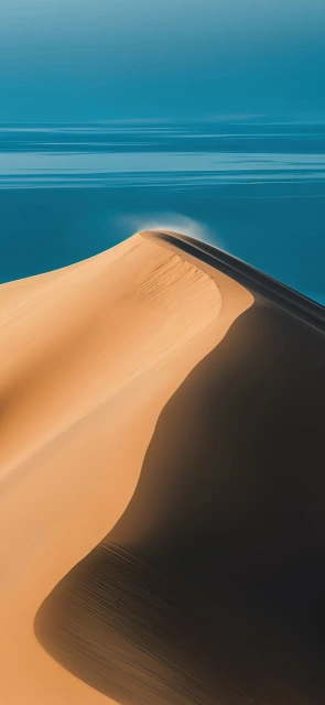 Sand Dune Crest Against Blue Sky