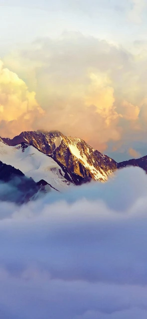 Snowy Mountain Peaks Above Clouds