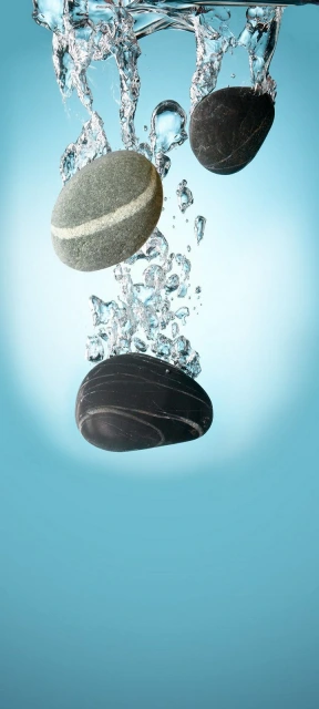 Stones falling into water