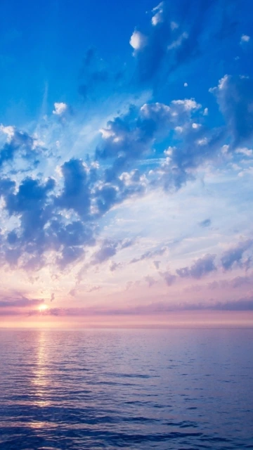 Sunset Over Ocean With Clouds