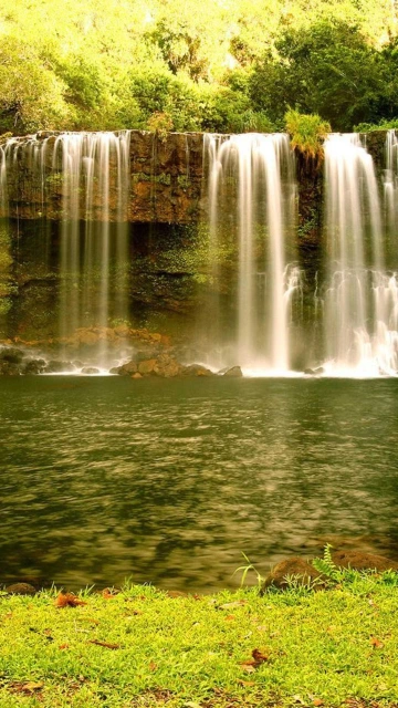 Waterfall Cascading Into Green Pool