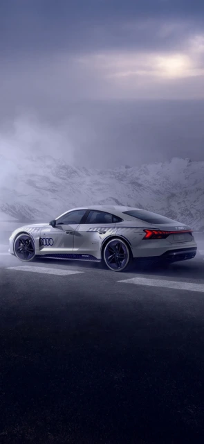 Audi e tron GT driving on snowy mountain road