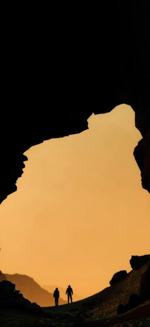 Silhouette of Two Hikers at Cave Entrance