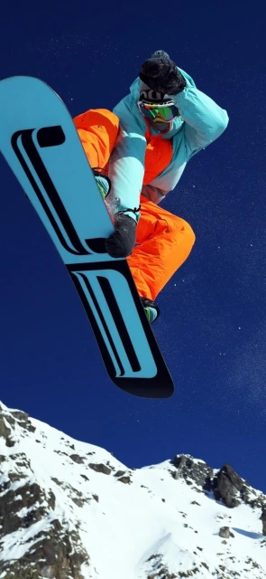 Snowboarder mid air jump