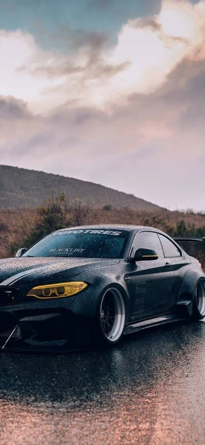 Black Modified Car on Wet Road