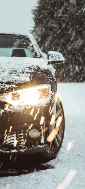 Car in Snow With Headlights