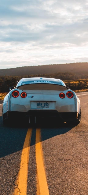 Rear View White Sports Car on Road