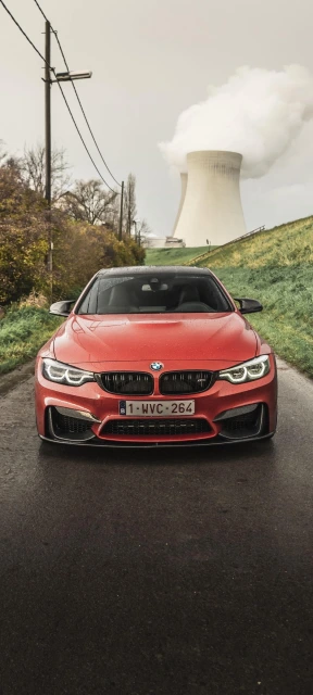 Red BMW Car With Cooling Tower