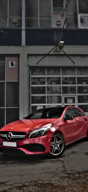 Red Mercedes Parked Outside Building