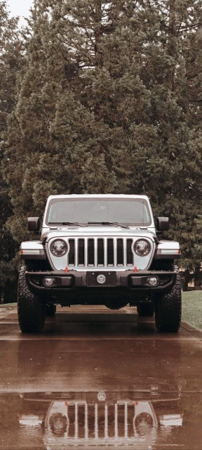 White Jeep Reflection on Wet Ground