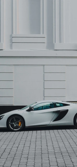 White Sports Car Parked on Brick