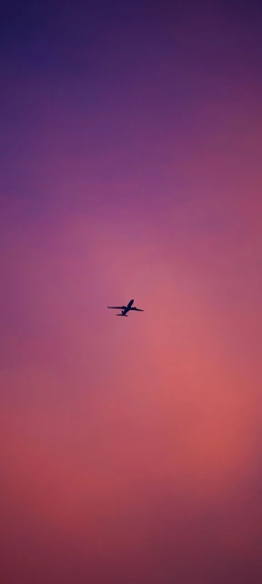 Airplane Silhouette Against Sunset Sky
