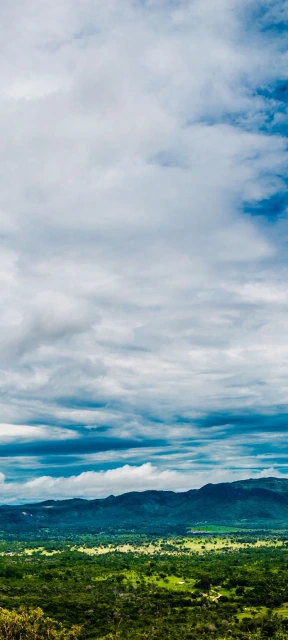 Cloudy Sky Over Green Hills