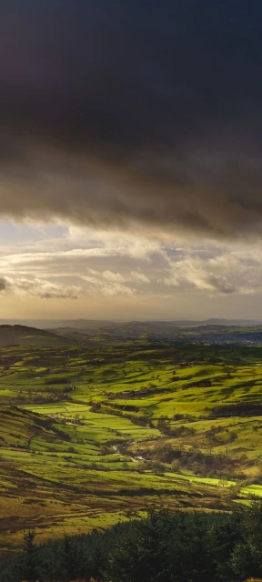 Green Hills Under Dark Storm Clouds