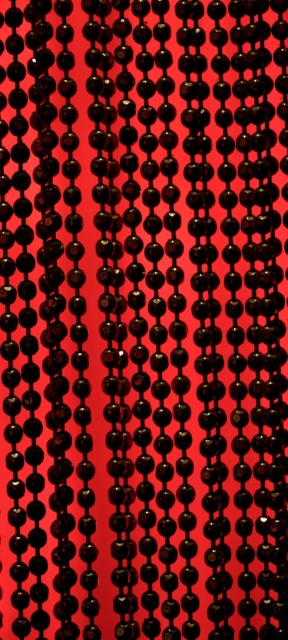 Black Bead Curtain on Red Background