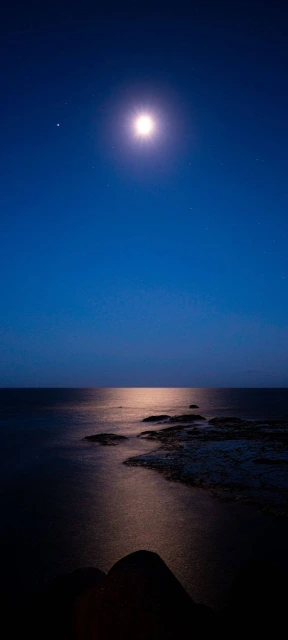 Bright Moon Over Ocean at Night