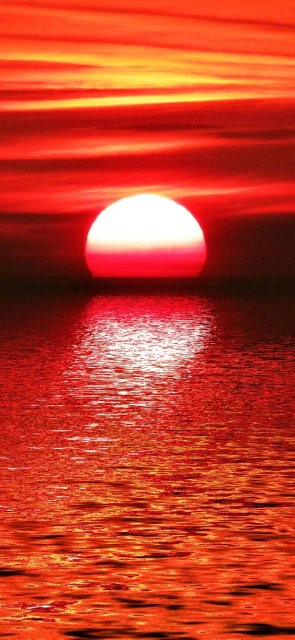 Sunset Over Water With Red Sky