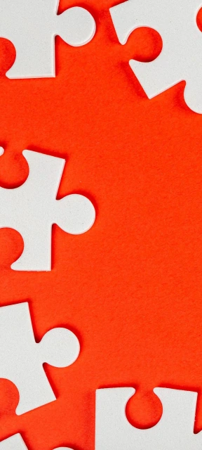 White Puzzle Pieces on Orange Background