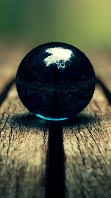 Dark Glass Marble on Wood