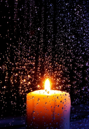 Rain View With Burning Candle